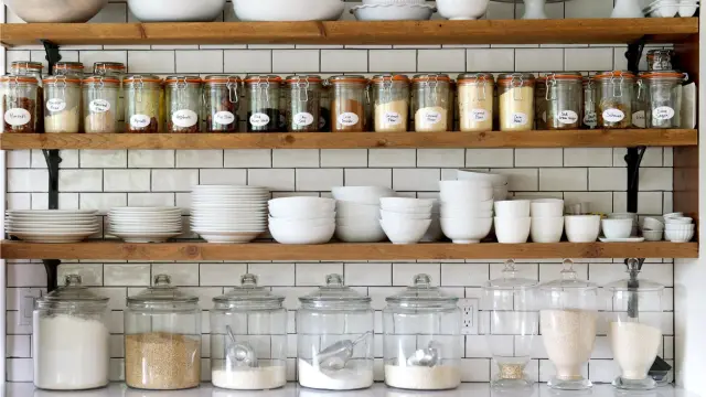 spice organizer rack with labeled jars inside kitchen cabinet